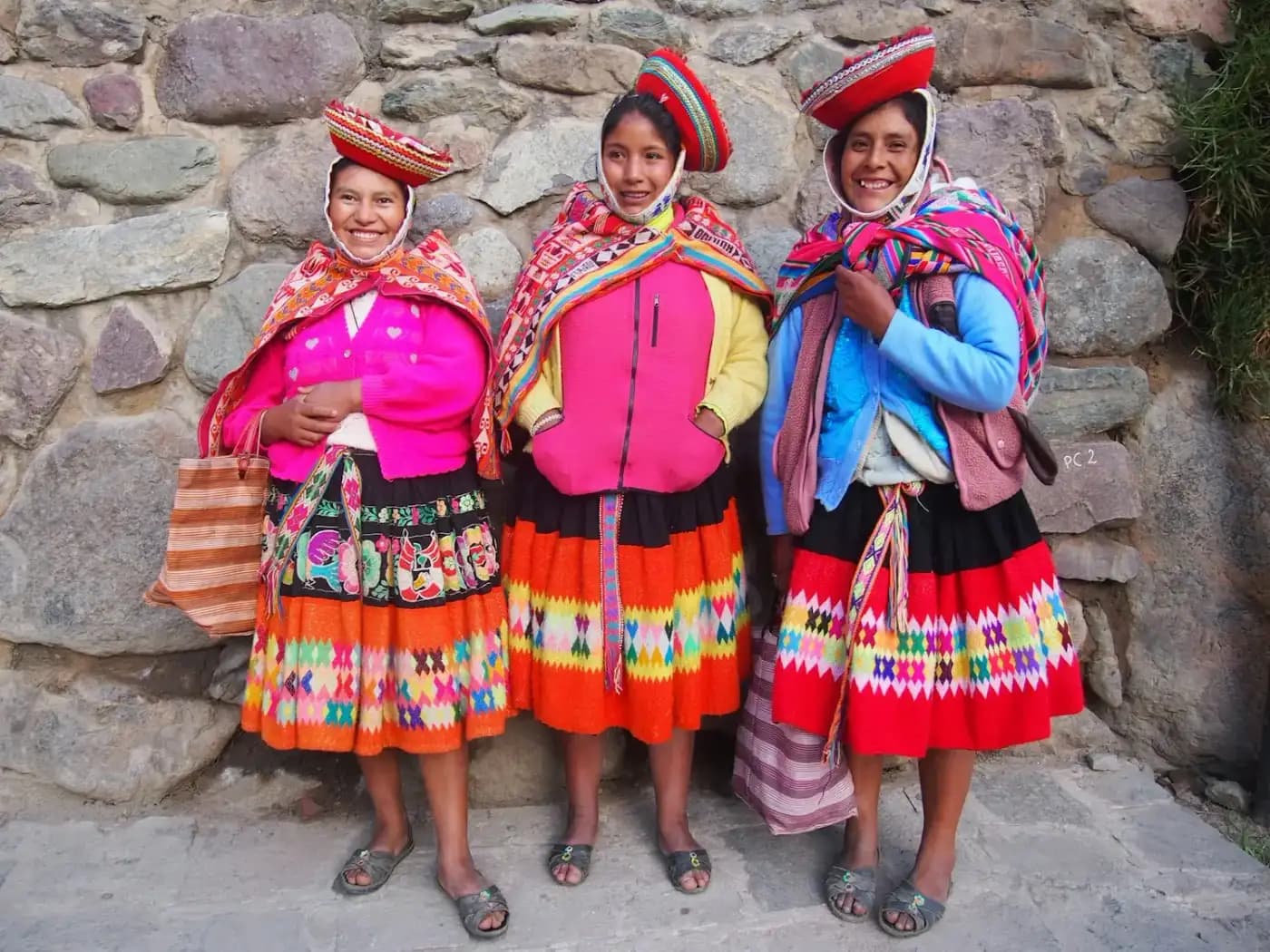 Three women in traditional Andean dress