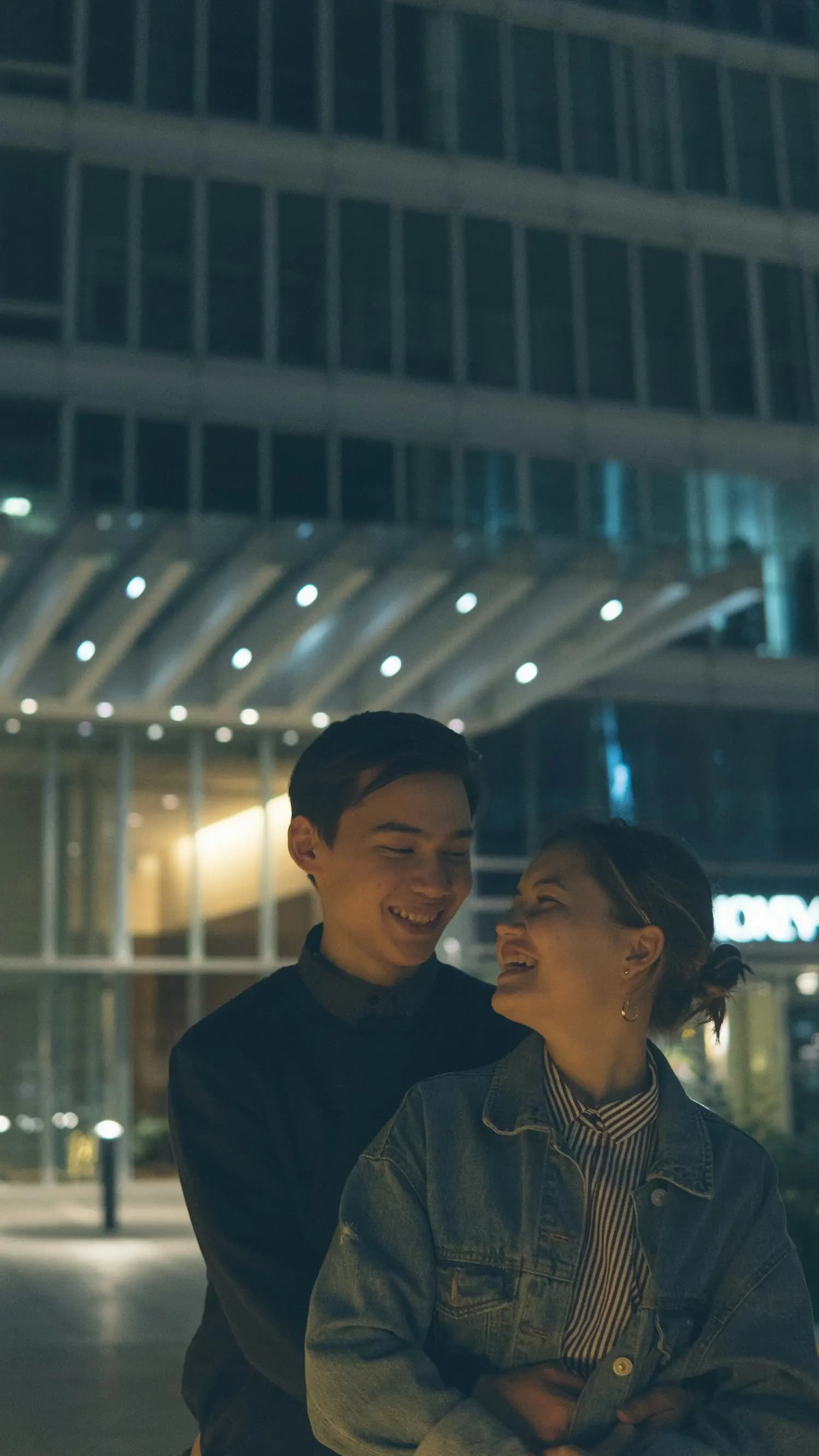 A couple embracing in the city at night
