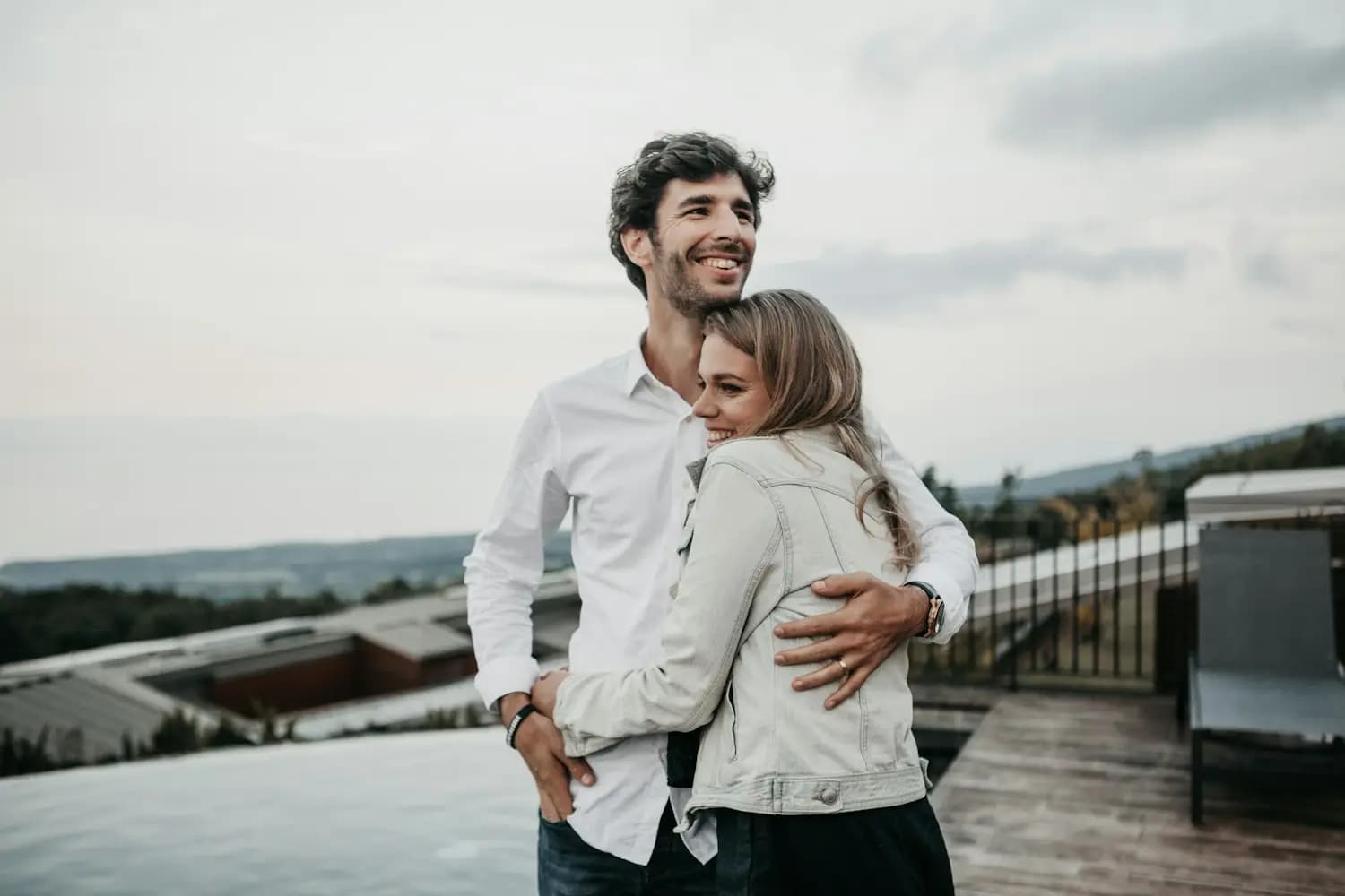 A couple hugging on a terrace