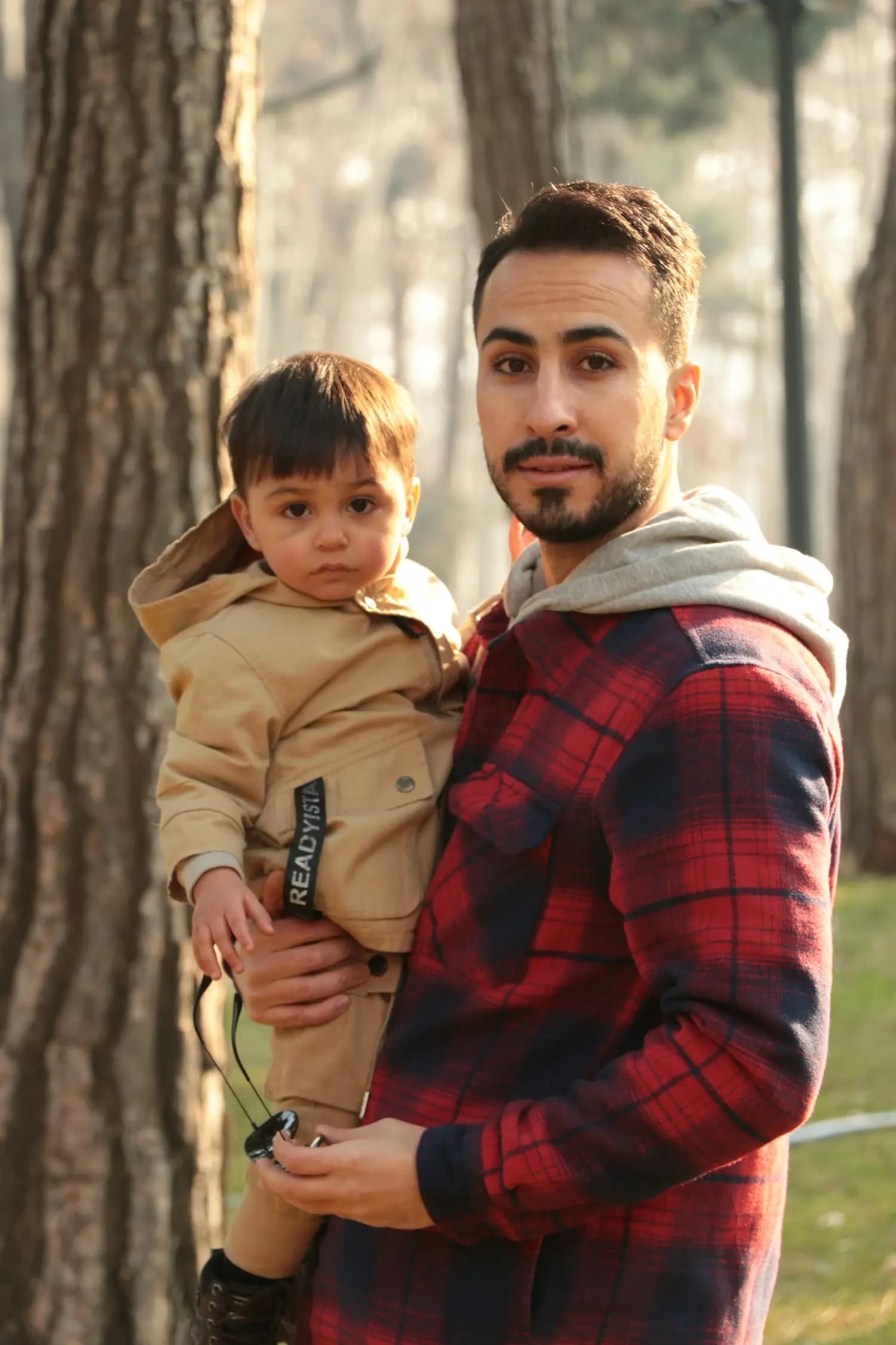 A father carries his son
